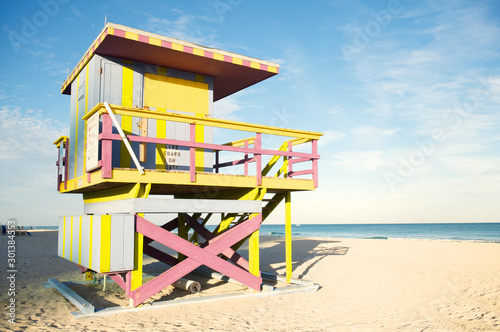 Scenic afternoon view of traditional aging lifeguard tower in weathered pastel colors in South Beach, Miami, Florida © PeskyMonkey
