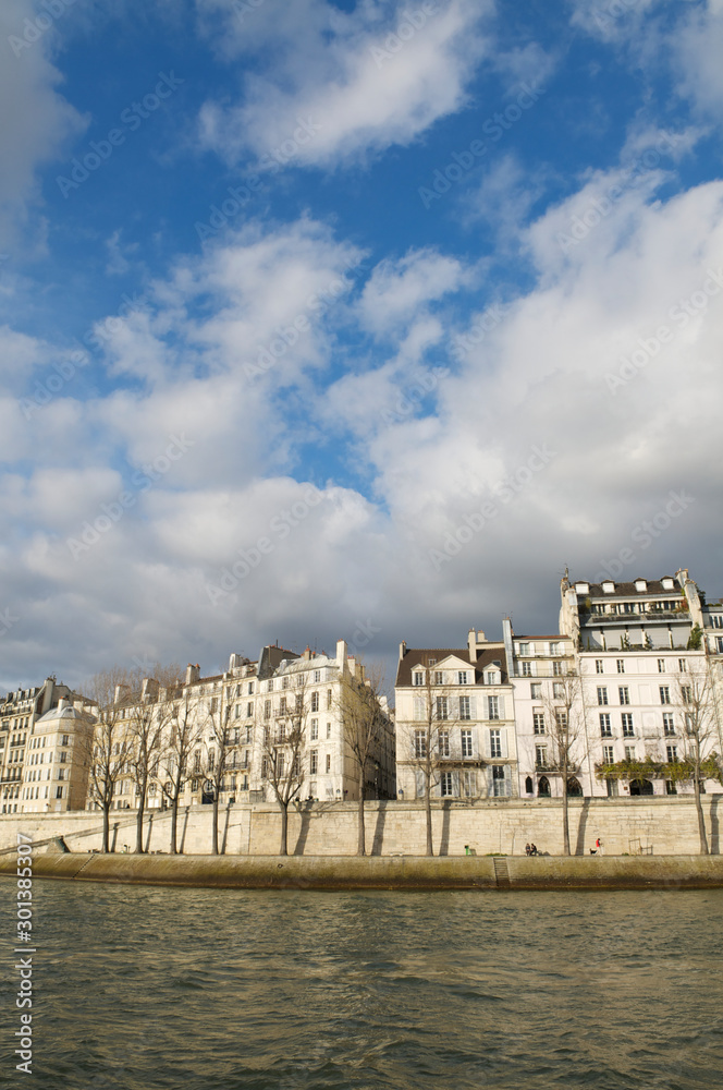 Classic view of the Paris cityscape from the banks of the River Seine on a sunny spring afternoon