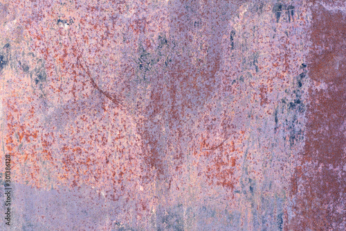 The corroded colored metal background.Rusty and scratched metal wall. Rusty metal background with rust spots.