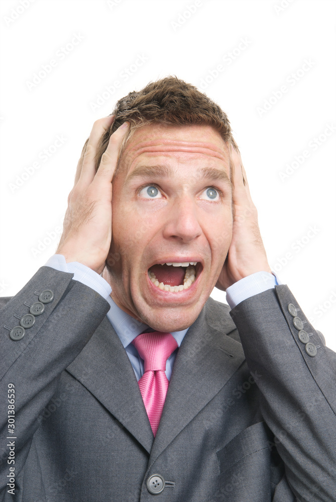 Stressed businessman holding his head screaming against white background Stressed businessman holding his head screaming against white background