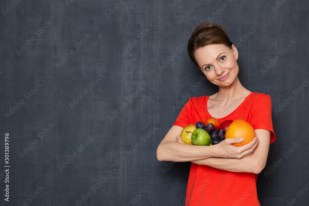 Portrait of happy young woman holding ripe fresh fruits in hands Portrait of happy young woman holding ripe fresh fruits in hands