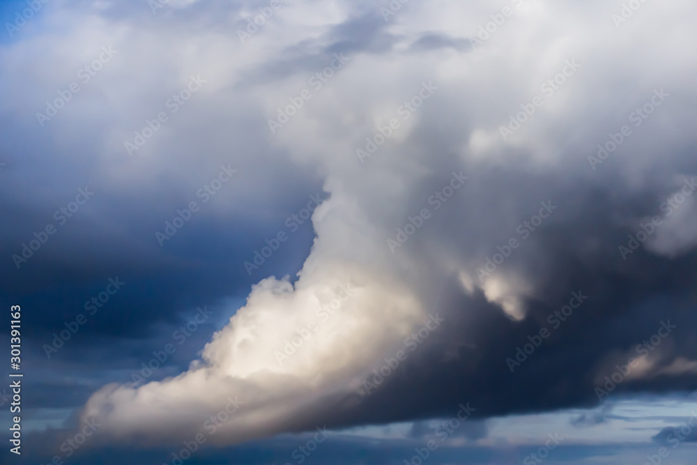 Beautiful thunderclouds. Fluffy volumetric clouds before a thunderstorm. Image without focus for design.