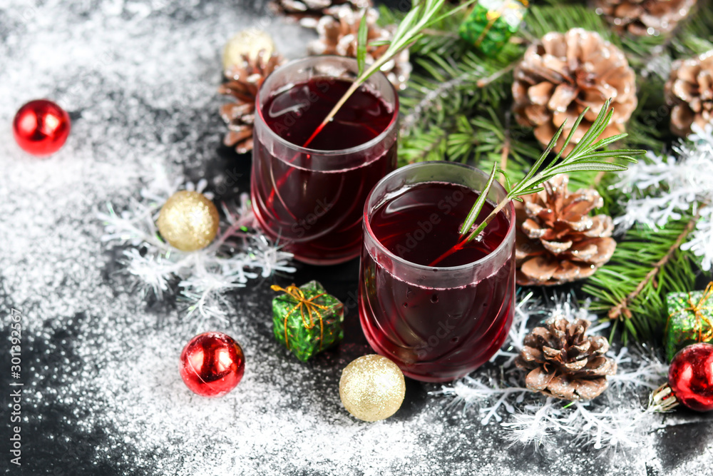 Christmas red wine mulled wine with spices and on a dark background. Around the white snow. New Year. Christmas decorations, cinnamon sticks. Copy space. Christmas red wine mulled wine with spices and on a dark background. Around the white snow. New Year. Christmas decorations, cinnamon sticks. Copy space.