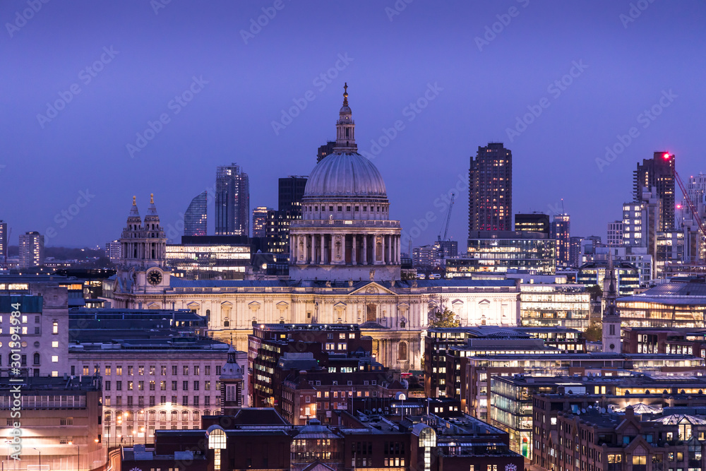 Modern London city skyline with St Pauls Cathedral at sunset night
