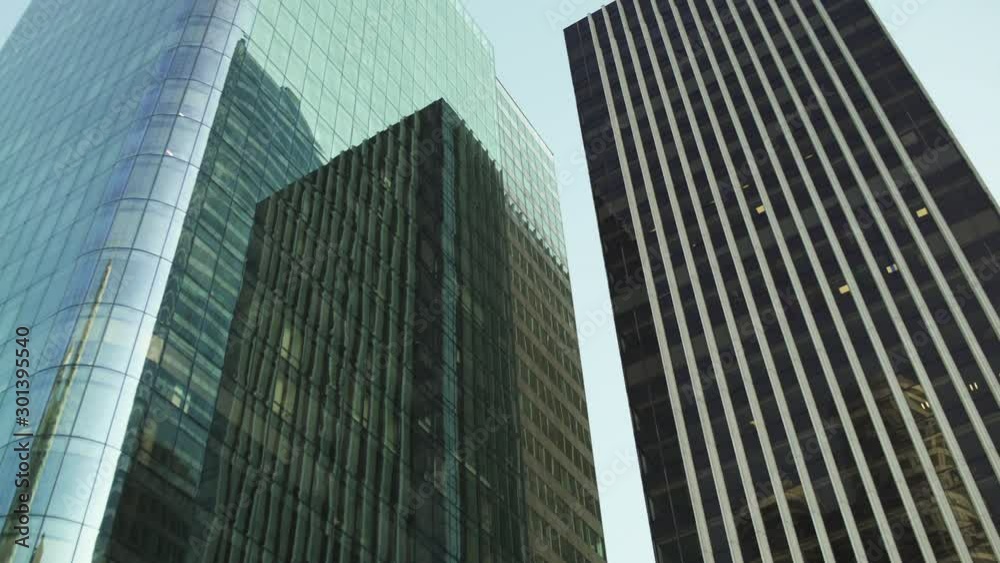 Skyscraper reflection with green glass windows at business district in Paris, slow steadicam movement side track to left, wide shot with reflections. Futuristic modern building in Blue Sky. 4K UHD. Skyscraper reflection with green glass windows at business district in Paris, slow steadicam movement side track to left, wide shot with reflections. Futuristic modern building in Blue Sky. 4K UHD.