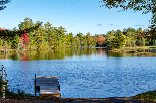 Fototapeta Naklejka Na Ścianę i Meble -  Evening on a quiet Lake Muskoka deck during Autumn