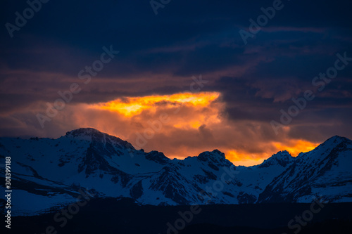 Sunlight leaking through clouds over the Rocky Mountains © erkangunes