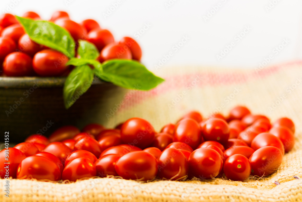 chery tomatoes on a linen sack with spices chery tomatoes on a linen sack with spices