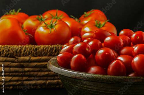 Angielski  chery tomatoes on the black background with spices