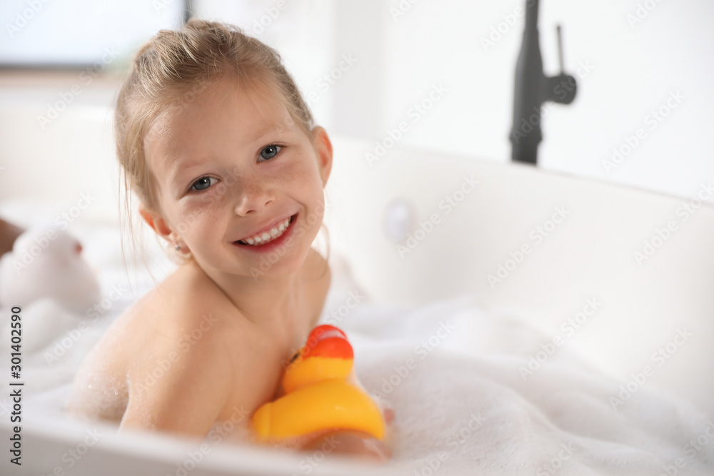 Cute little girl taking bubble bath at home Cute little girl taking bubble bath at home