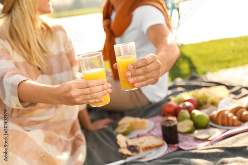 Young couple having picnic outdoors on sunny day, closeup