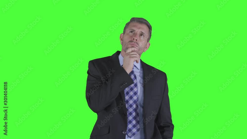 Thoughtful Caucasian businessman thinking idea or solution while looking up and holding his chin in the studio. Shot in 4k resolution with green screen background Thoughtful Caucasian businessman thinking idea or solution while looking up and holding his chin in the studio. Shot in 4k resolution with green screen background