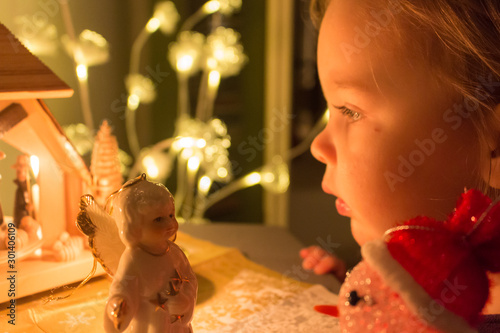 cute toddler staring at nativity play at christmas