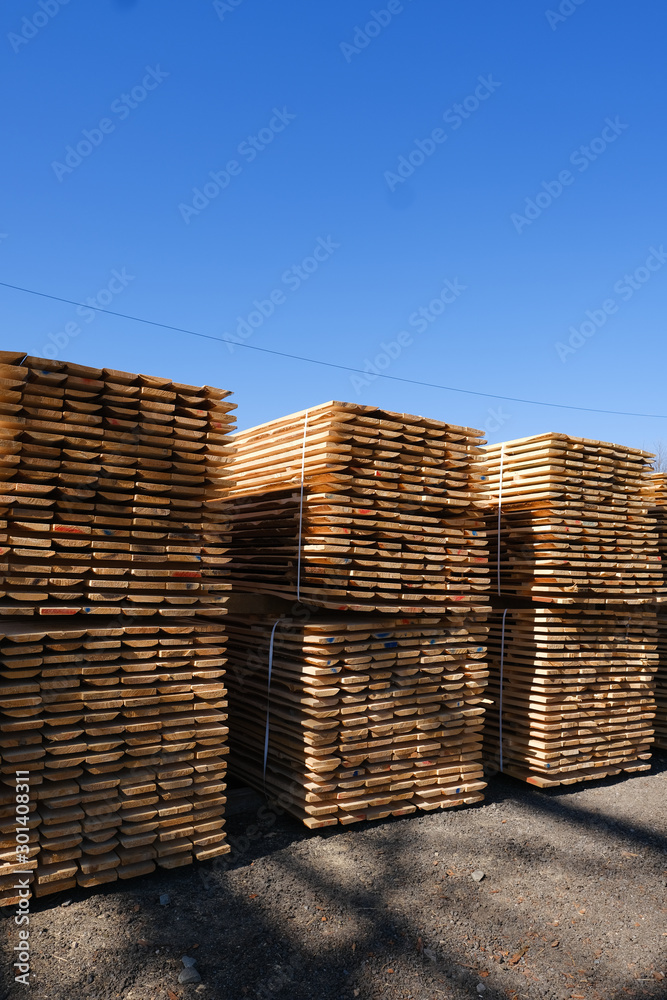 Wood timber in the sawmill. Piles of wooden boards in the sawmill. Wood timber in the sawmill. Piles of wooden boards in the sawmill.