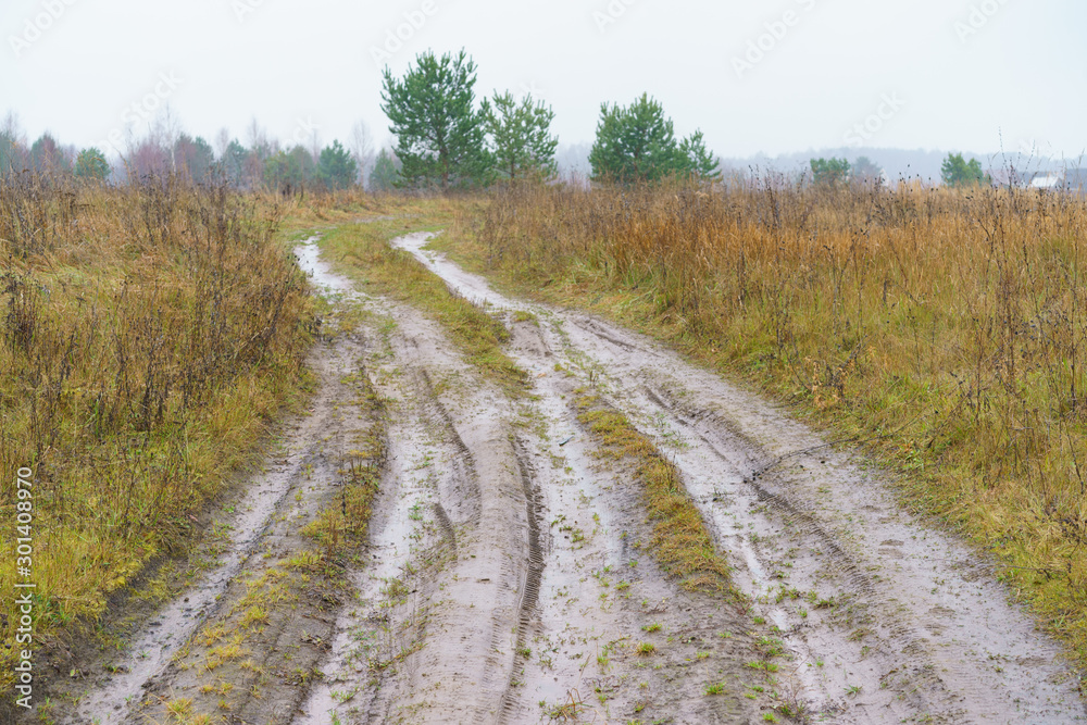 Photography of Russian country road in rainy day. Autumn landscape in Moscow region. Concepts of travel and touristic mood and beauty of nature in bad weather. Photography of Russian country road in rainy day. Autumn landscape in Moscow region. Concepts of travel and touristic mood and beauty of nature in bad weather.