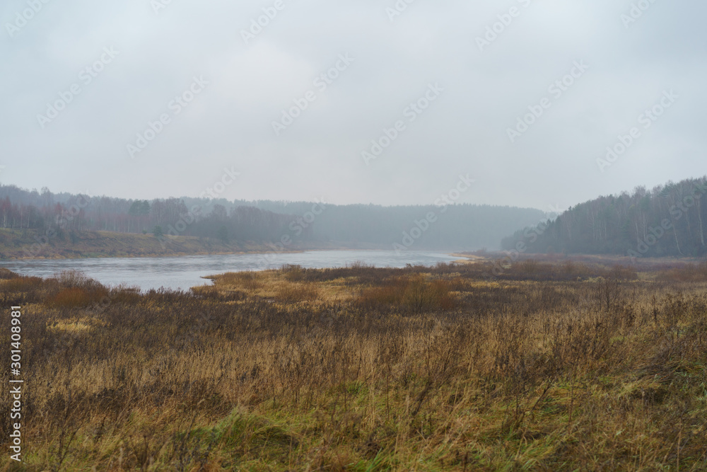 Photography of Russian country side in rainy day. Autumn landscape. Famous Volga river in Tver region. Concepts of travel and touristic mood and beauty of nature in bad wet weather.