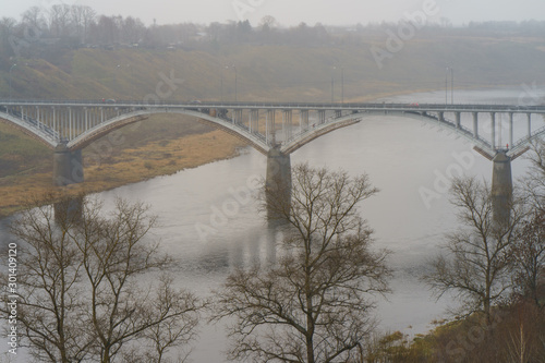 Photography of Bridge across Volga river in Staritsa town. Top view / View from above. Rainy autum day in russian countryside in Tver oblast / region.