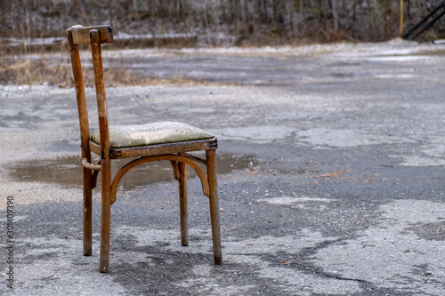 Vintage worn out chair on the street.