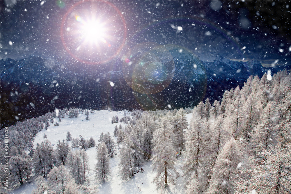 Fototapeta premium Christmas background with snowy fir trees and mountains in heavy blizzard.