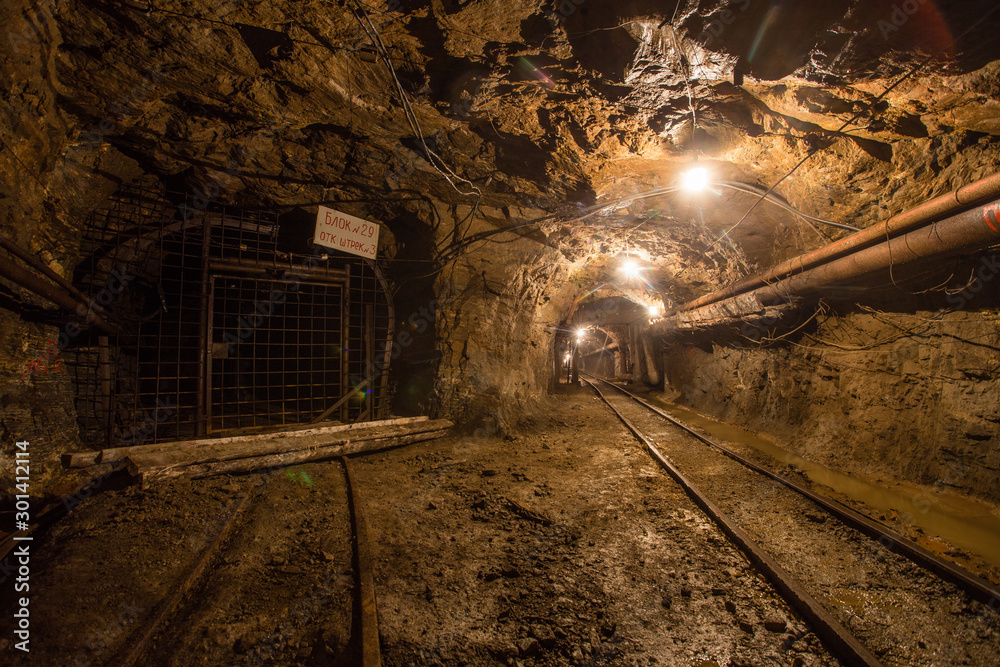 Naklejka premium Gold iron mine ore shaft tunnel drift with rails underground