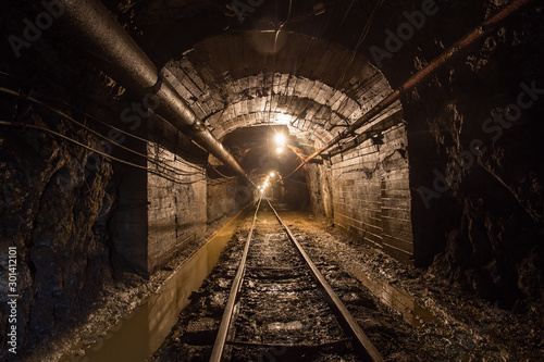Fototapeta Naklejka Na Ścianę i Meble -  Gold iron mine ore shaft tunnel drift with rails underground