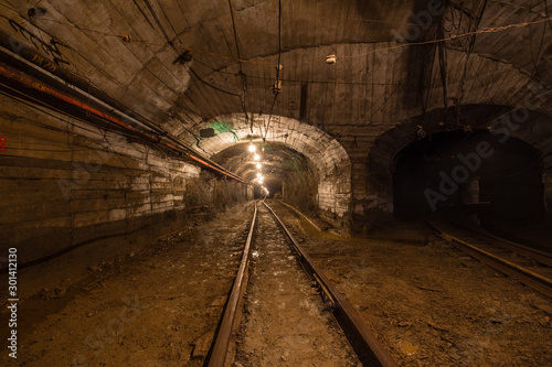 Gold iron mine ore shaft tunnel drift with rails underground © Mishainik