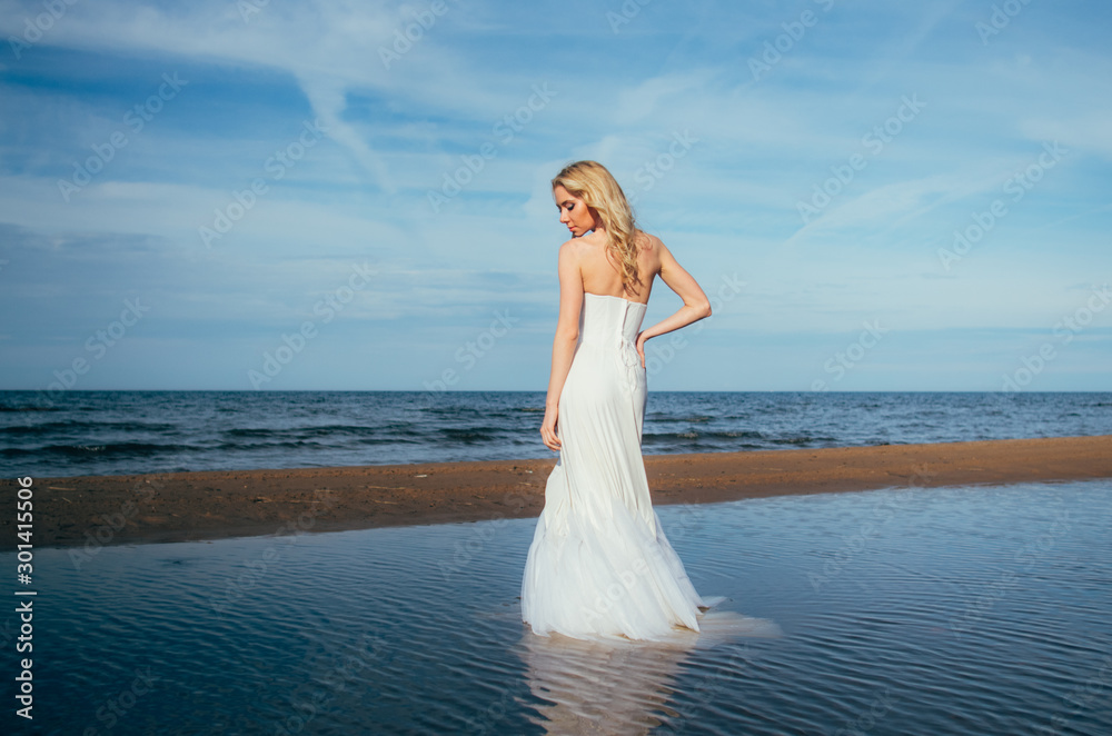 Portrait of young blond bride staying among the water Portrait of young blond bride staying among the water