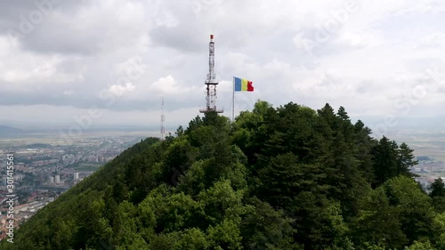 4K Drone Aerial Romanian Flag Brasov City Carpathian Mountains Summer Blue Sky photo