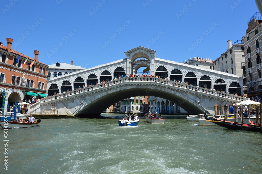 Venice (Italy). June 2019. The two banks of the Grand Canal are connected by the Rialto Bridge.  In the XVI century. architect Antonio de Ponte proposed the construction of an arch bridge. 