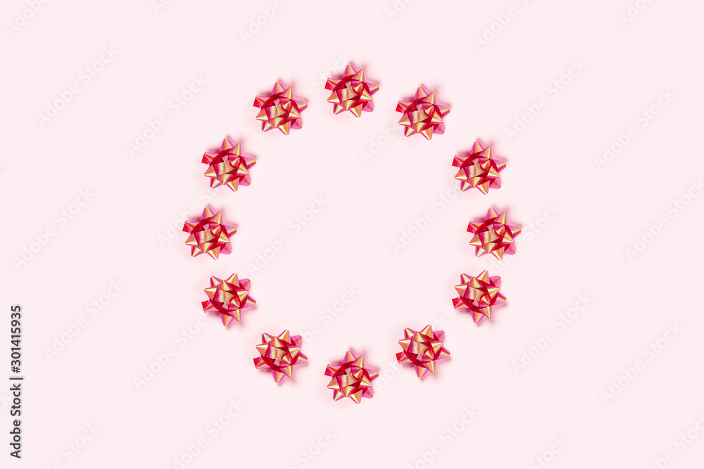 Christmas pink background with circle frame of bows.