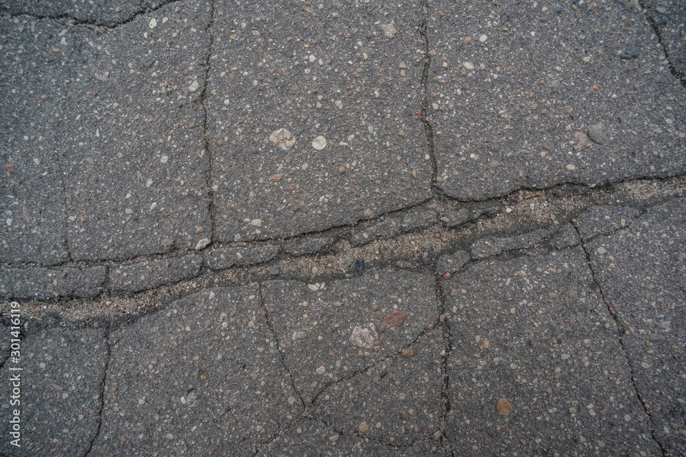 Obraz premium The surface of the old asphalt cracked