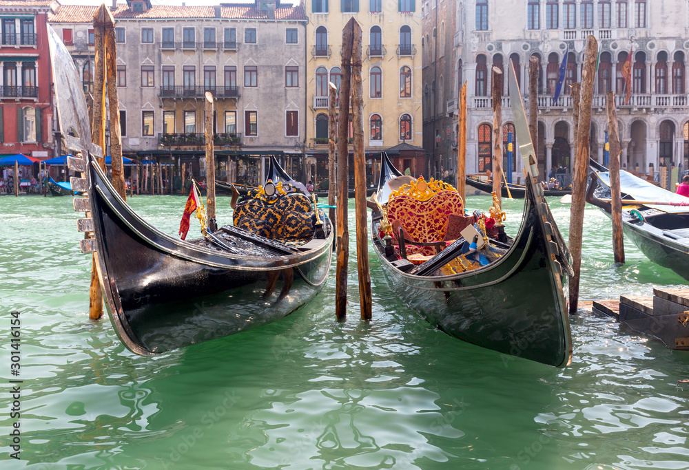 Black gondolas at the pier on the Grand Canal.