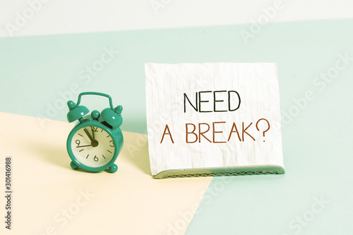 Conceptual hand writing showing Need A Brake Question. Concept meaning More Time to Relax Chill Out Freedom Stress Free Alarm clock beside a Paper sheet placed on pastel backdrop