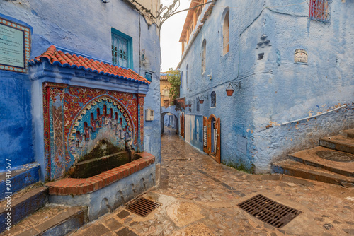 Water fountain on a  street of Chefchaouen the Blue city of Morocco © Helen Filatova