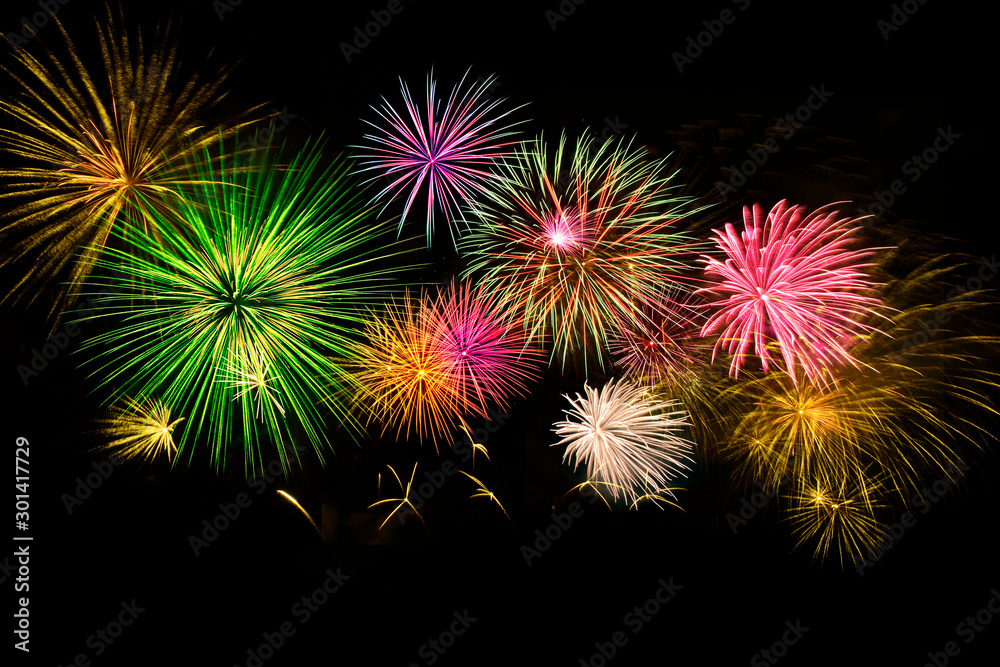 Colorful fireworks on midnight sky background.
