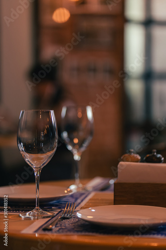 Wine glasses on the banque table in restaurant.