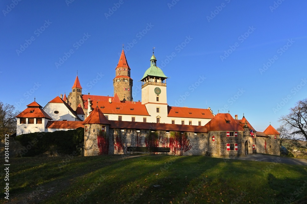 Beautiful old romantic Bouzov castle at sunset with autumn landscape.