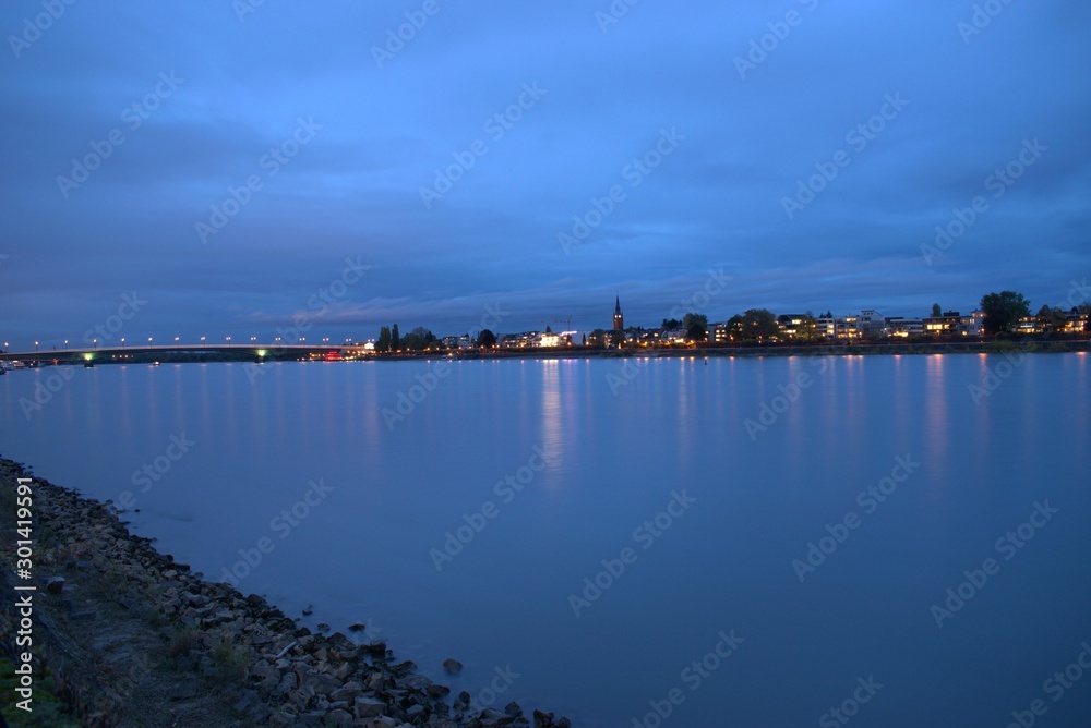 Blau dämmender Rhein mit der Skyline Bonn's