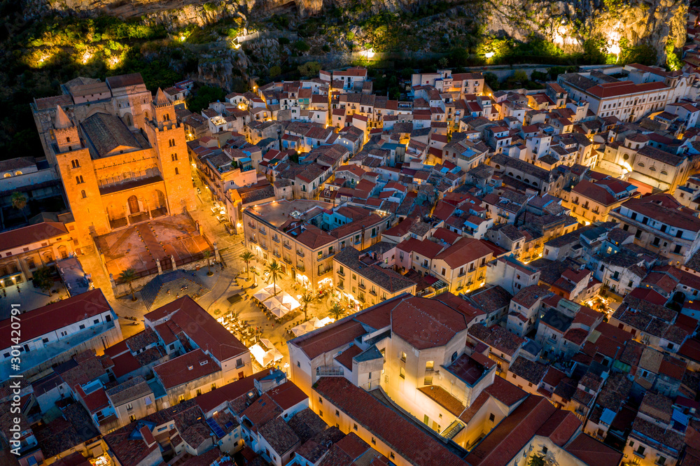 Top view on night streets of Cefalu with the city lights. Sicily, Italy