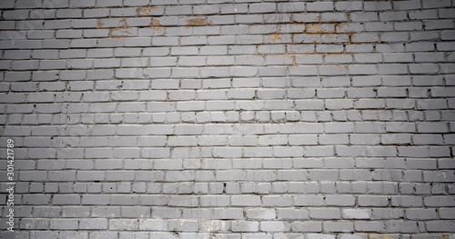 Rough aged masonry background. Backdrop of old white bricks with shabby texture