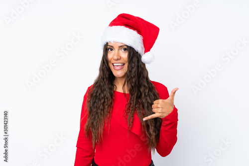 Girl with christmas hat over isolated white background making phone gesture