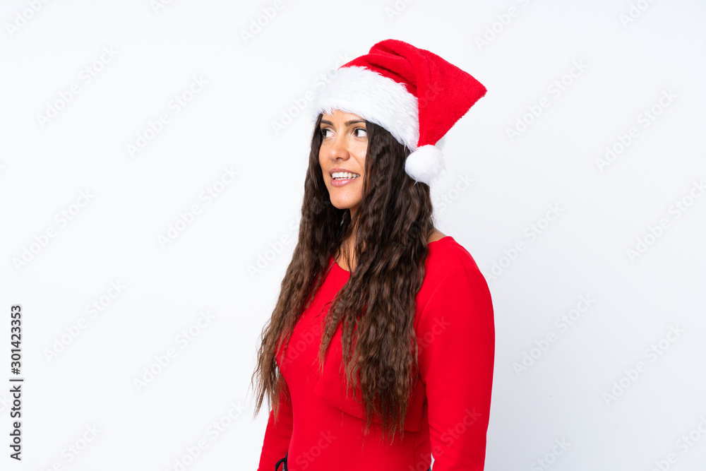 Girl with christmas hat over isolated white background looking to the side Girl with christmas hat over isolated white background looking to the side