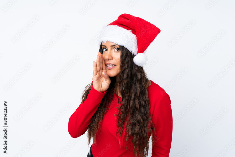 Girl with christmas hat over isolated white background whispering something Girl with christmas hat over isolated white background whispering something