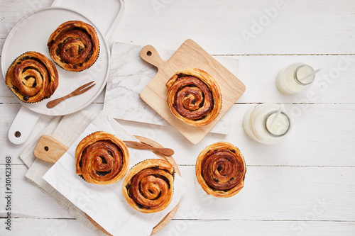 Fresh danish pastry with raisins on wood background.Tasty sweet bakery.