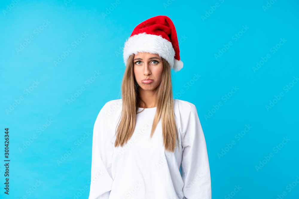 Girl with christmas hat over isolated background sad Girl with christmas hat over isolated background sad