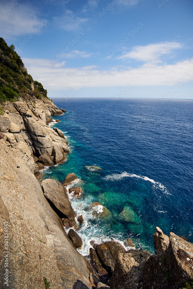 Fototapeta premium cliffs near Portofino, Italy, a crytal clear sea and a blue sky with some clouds