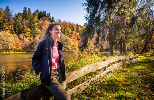 Fall autumn hiker girl at mountains with backpack for camping travel trip photo