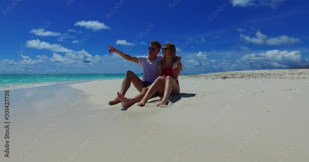Romantic Tourist Couple Enjoy The Bright Summer Day By Sitting At the Seashore and Watch The Glorious View of the Island With Perfect Cloudy Sky Above in Mexico - Rolling Shot Romantic Tourist Couple Enjoy The Bright Summer Day By Sitting At the Seashore and Watch The Glorious View of the Island With Perfect Cloudy Sky Above in Mexico - Rolling Shot