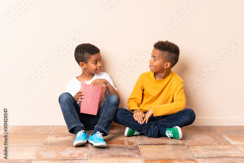 African American brothers holding popcorns