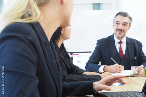 Tablou pe pânză Senior manager talking to his colleagues in the meeting time for new project pla